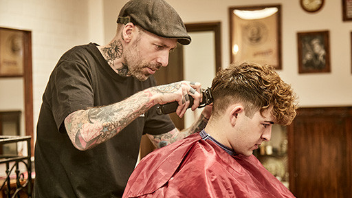 Bond's Barbershop Bournemouth - Barber cutting hair