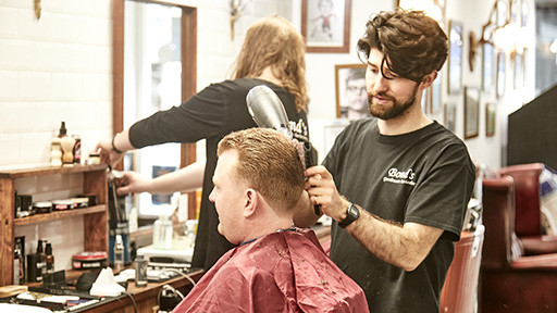 Bond's Barbershop Bournemouth - Barber blowdrying hair