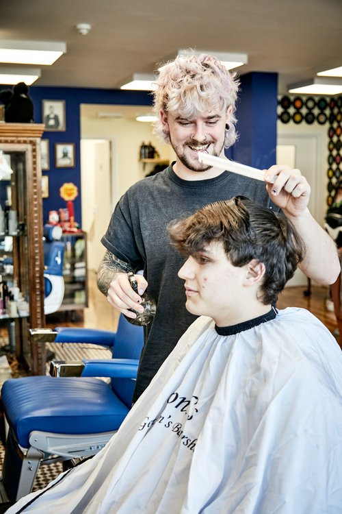 Bond's Barbershop Broadstone - Barber spraying a customer's hair with water spray