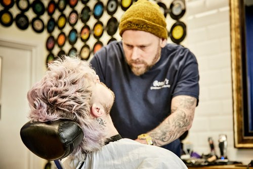 Bond's Barbershop Broadstone - Barber shaving the beard of a customer