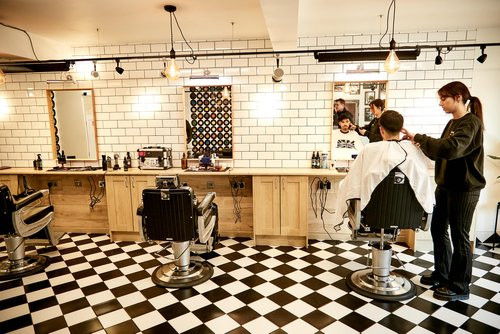 Bond's Barbershop Fordingbridge - 3 barber chairs with a barber cutting the hair of a customer