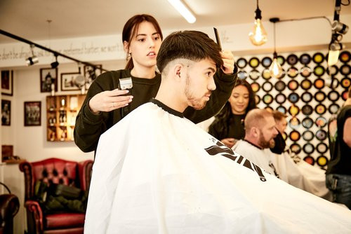 Bond's Barbershop Fordingbridge - 3 barbers cutting the hair of customers