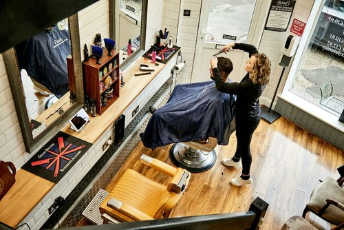 Bond's Barbershop Poole - Top down view of a barber cutting a customer's hair