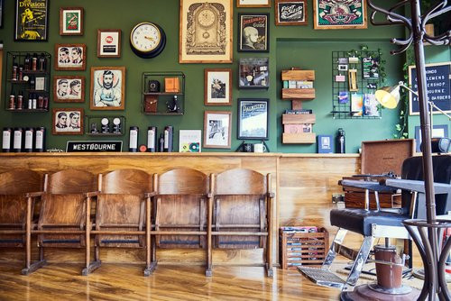 Bond's Barbershop Westbourne - waiting area, products and pictures on wall